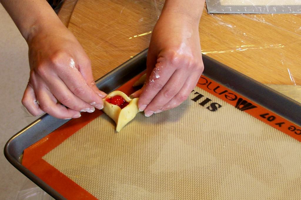 Hamentashen-fixing; photo by L. Goldman Photo #6: Last touches