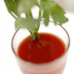 Glass of Tomato Juice Garnished with a Celery Stick