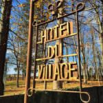 Hotel du Village sign