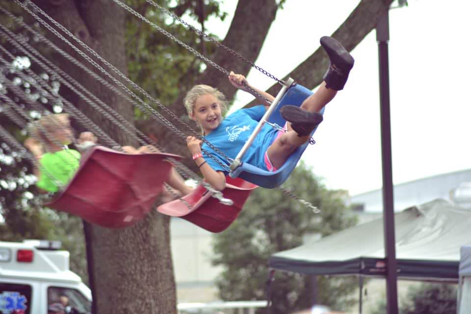 Girl on a swing at a past Polish-American Festival